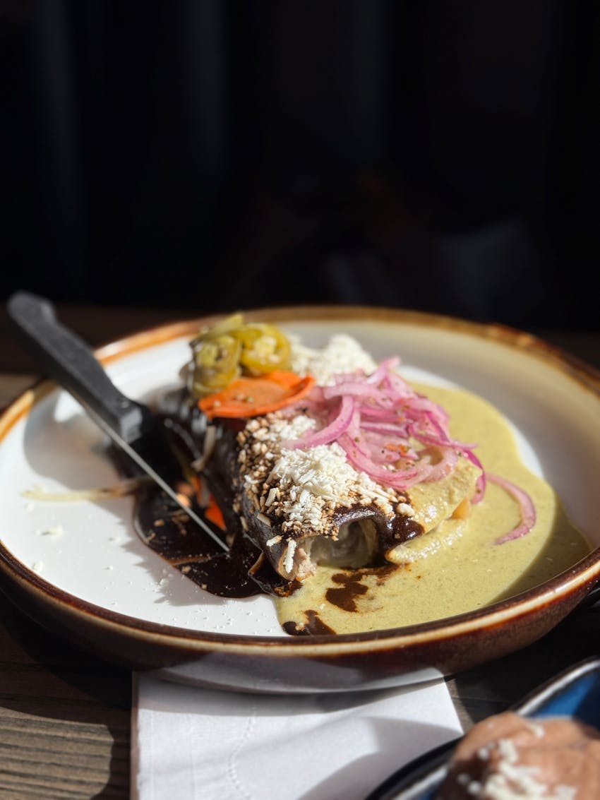 Mexican enchilada plate served with sauce