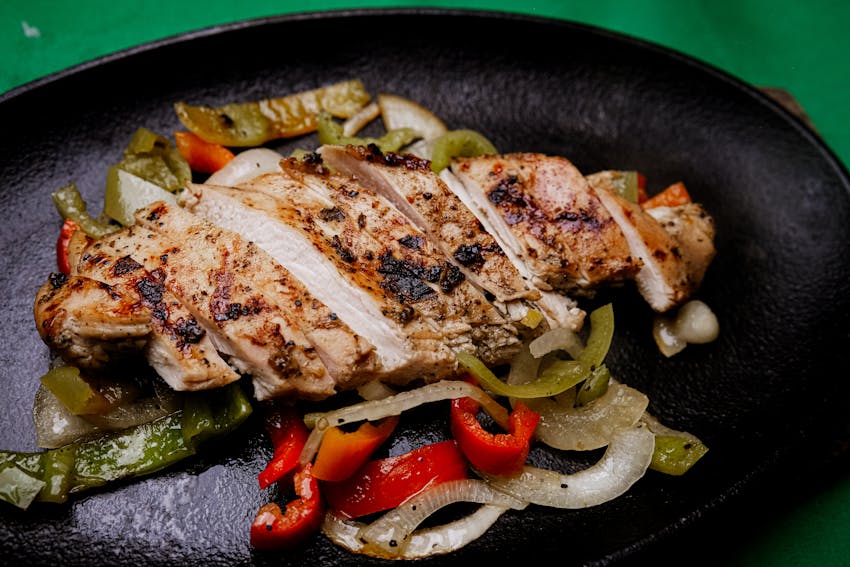 Sizzling beef fajitas in a cast-iron skillet